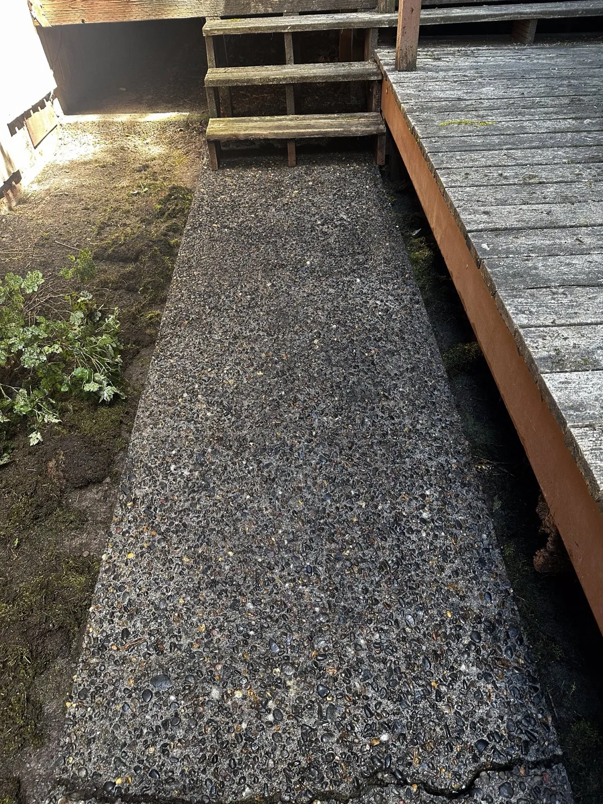 Clean aggregate walkway beside deck stairs