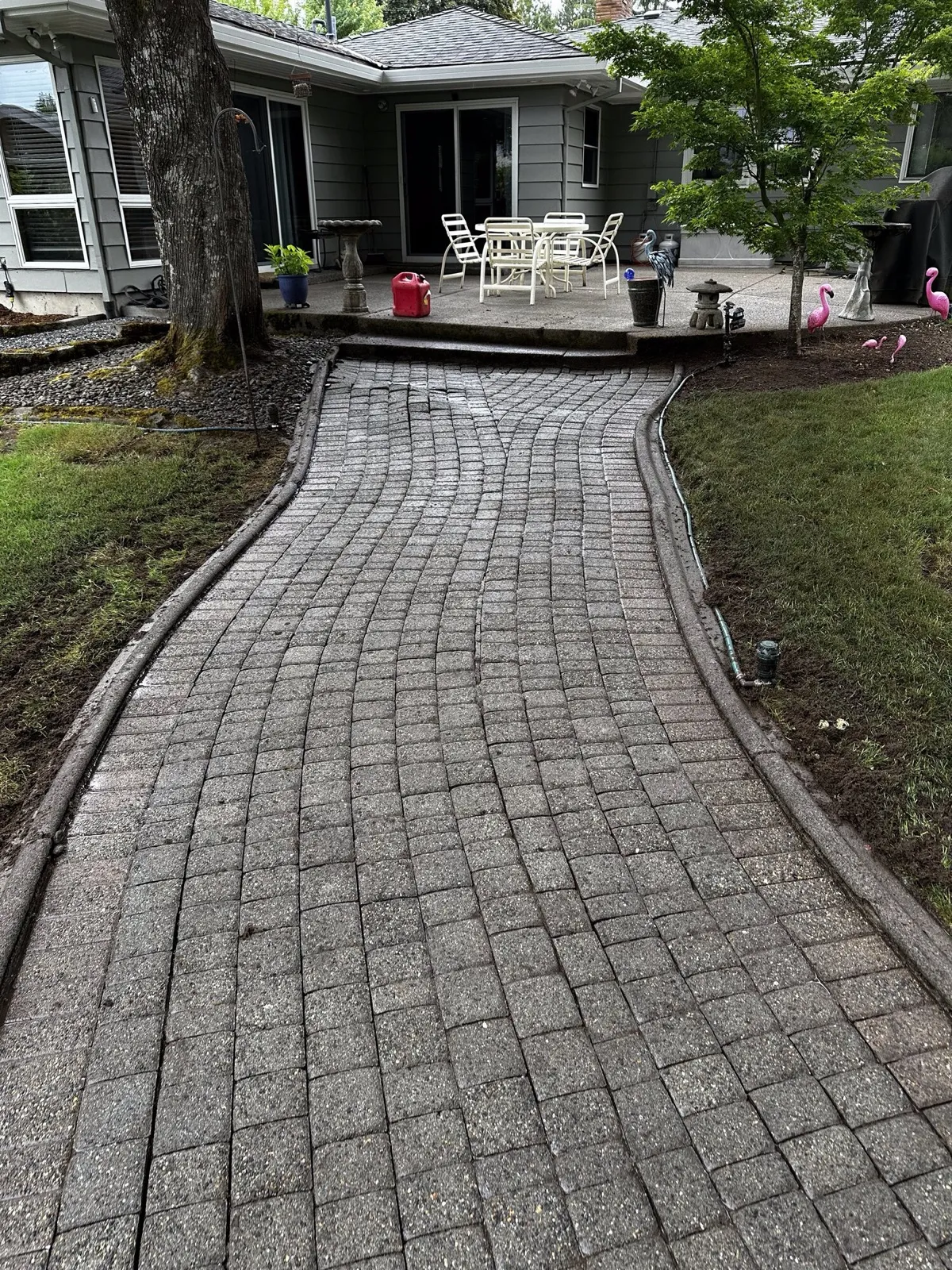 After: the same paver path clean, patio furniture beyond