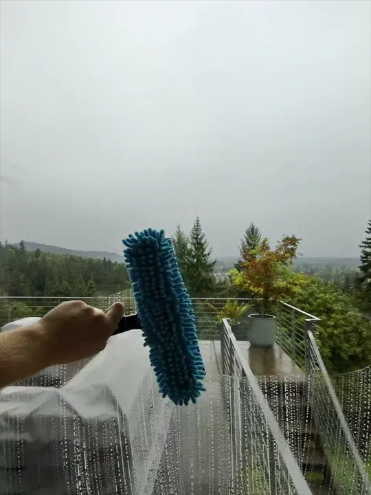 Julian cleaning exterior windows on a Portland home